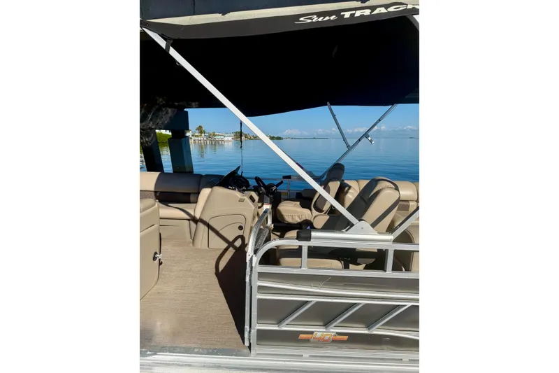 Slide: The Image of 2023 Sun Tracker Party Barge 22 DLX pontoon boat with canopy on calm water. - 3