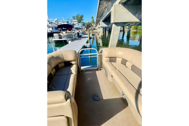 Slide: The Image of 2023 Sun Tracker Party Barge 22 DLX pontoon boat docked near a marina. - 4