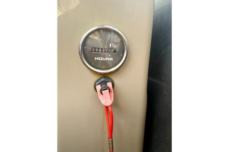 Slide: The Image of Hour meter and ignition switch on 2023 Sun Tracker Party Barge 22 DLX. - 7