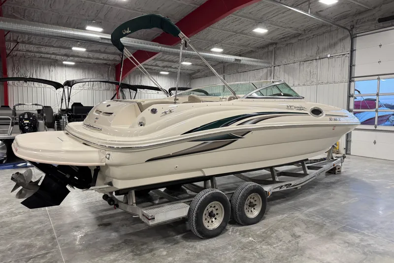 Slide: The Image of 2004 Sea Ray 240 Sundeck boat on trailer in indoor storage facility. - 3