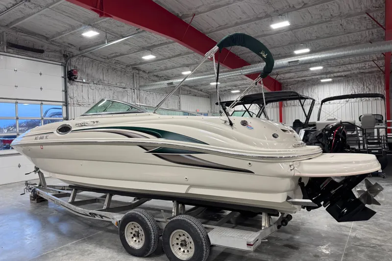 Slide: The Image of 2004 Sea Ray 240 Sundeck boat on trailer in indoor storage facility. - 4