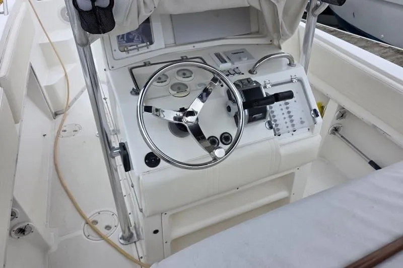 Slide: The Image of 2004 Fountain 31 Tournament Edition boat helm with steering wheel and control panel. - 12