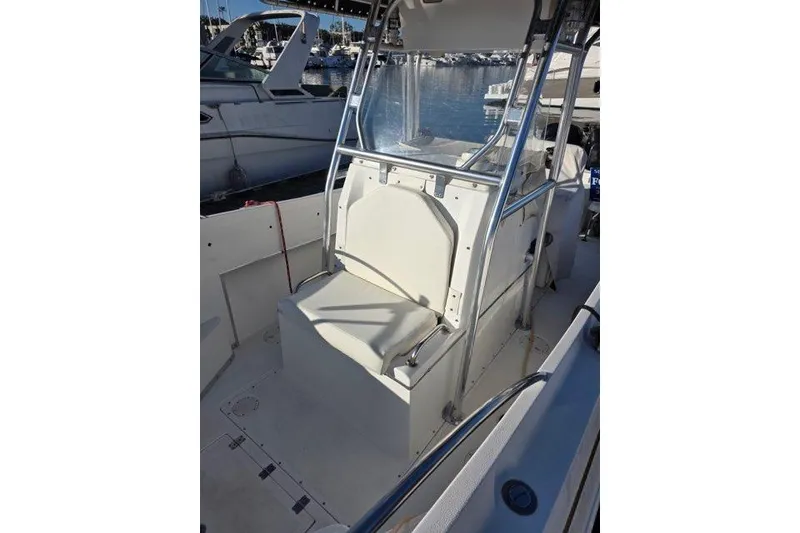 Slide: The Image of 2004 Fountain 31 Tournament Edition boat interior with seating and helm, docked at marina. - 14