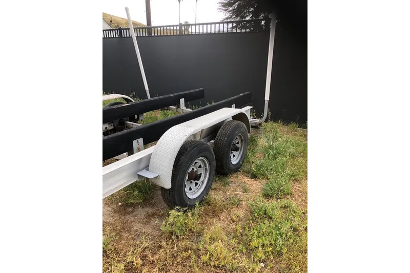 Slide: The Image of Trailer for 2004 Fountain 31 Tournament Edition boat on grassy area. - 20