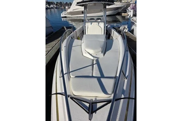Slide: The Image of 2004 Fountain 31 Tournament Edition boat docked at marina, showcasing sleek design and spacious deck. - 4