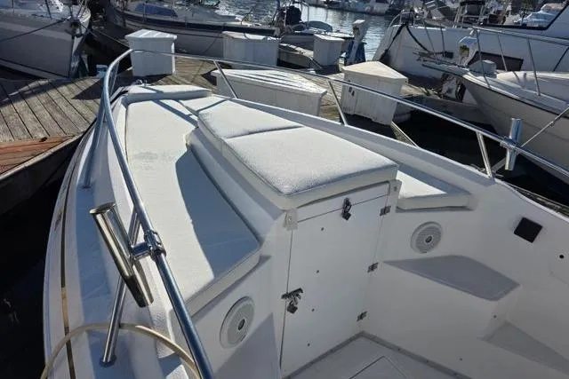 Slide: The Image of 2004 Fountain 31 Tournament Edition boat docked, featuring spacious seating and storage. - 5