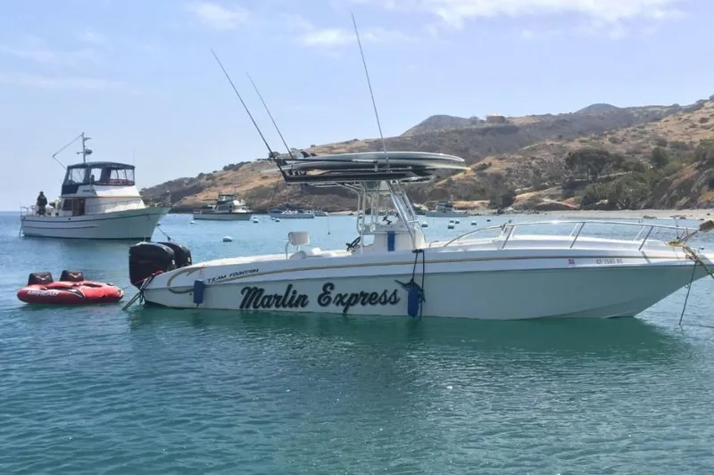 Slide: The Image of 2004 Fountain 31 Tournament Edition boat named "Marlin Express" anchored in scenic bay. - 6