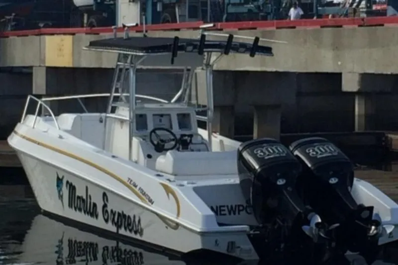 Slide: The Image of 2004 Fountain 31 Tournament Edition boat docked, featuring dual engines and "Marlin Express" branding. - 7