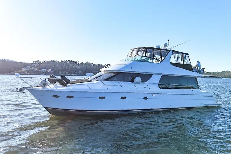 Slide: The Image of 2001 Carver 570 Voyager Pilothouse yacht on calm water, clear sky background. - 14