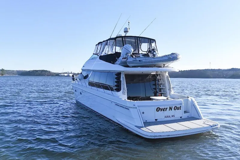 Slide: The Image of 2001 Carver 570 Voyager Pilothouse yacht on calm water, rear view. - 15
