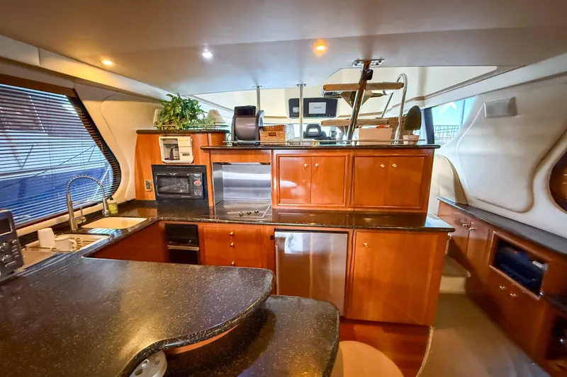 Slide: The Image of Luxurious interior of 2001 Carver 570 Voyager Pilothouse yacht kitchen area. - 21