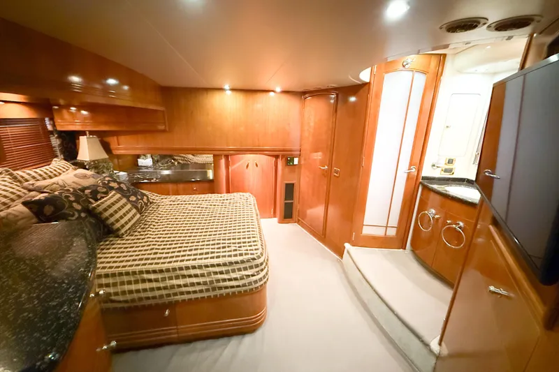 Slide: The Image of Luxurious interior of 2001 Carver 570 Voyager Pilothouse with elegant wood finishes and cozy bedding. - 33