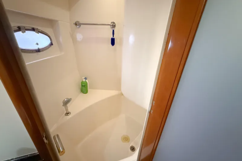 Slide: The Image of Shower area in 2001 Carver 570 Voyager Pilothouse yacht with porthole and toiletries. - 37