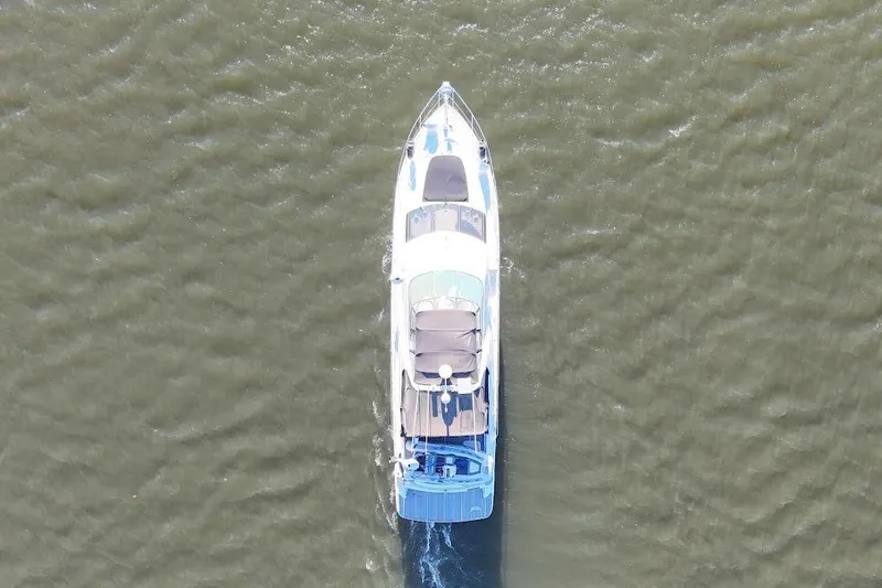 Slide: The Image of Aerial view of 2001 Carver 570 Voyager Pilothouse yacht cruising on water. - 6