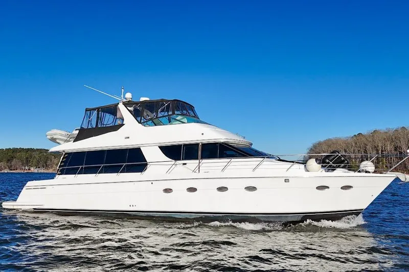 Slide: The Image of 2001 Carver 570 Voyager Pilothouse yacht cruising on a clear blue day. - 9