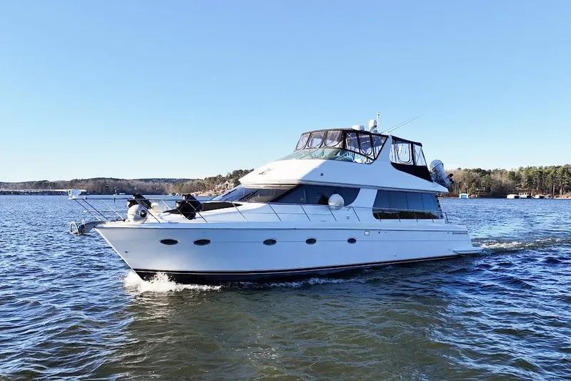 Slide: The Image of 2001 Carver 570 Voyager Pilothouse yacht cruising on a sunny day. - 11