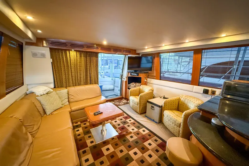 Slide: The Image of Luxurious interior of 2001 Carver 570 Voyager Pilothouse yacht with cozy seating and modern amenities. - 19