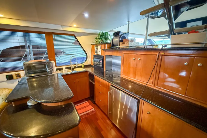 Slide: The Image of Luxurious kitchen interior of 2001 Carver 570 Voyager Pilothouse yacht with modern amenities. - 20