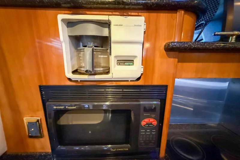 Slide: The Image of 2001 Carver 570 Voyager Pilothouse kitchen with coffee maker and microwave. - 22