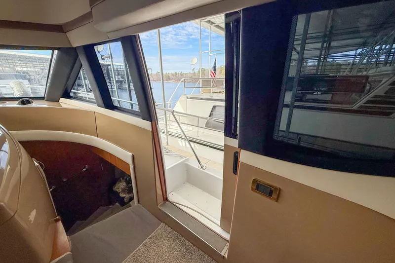 Slide: The Image of Interior view of 2001 Carver 570 Voyager Pilothouse, showing stairs and open door to deck. - 26