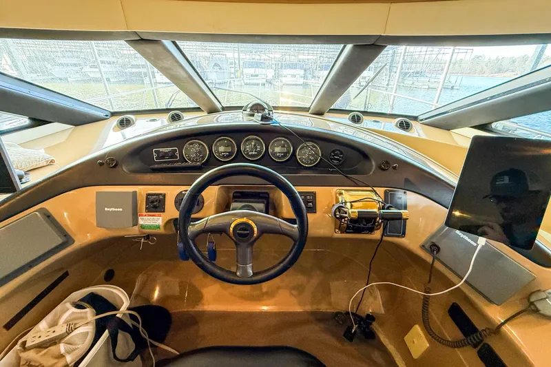 Slide: The Image of Interior view of 2001 Carver 570 Voyager Pilothouse helm with steering wheel and navigation instruments. - 28