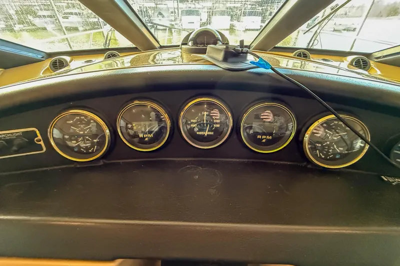 Slide: The Image of Dashboard of a 2001 Carver 570 Voyager Pilothouse with RPM gauges and controls. - 29