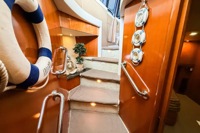 Slide: The Image of Interior of 2001 Carver 570 Voyager Pilothouse with wooden stairs and nautical decor. - 32