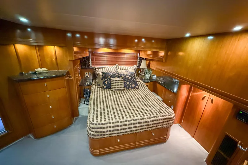 Slide: The Image of Luxurious bedroom interior of 2001 Carver 570 Voyager Pilothouse yacht with elegant wood finish. - 34