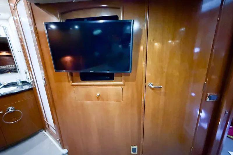 Slide: The Image of Interior of 2001 Carver 570 Voyager Pilothouse with mounted TV and wooden cabinetry. - 39
