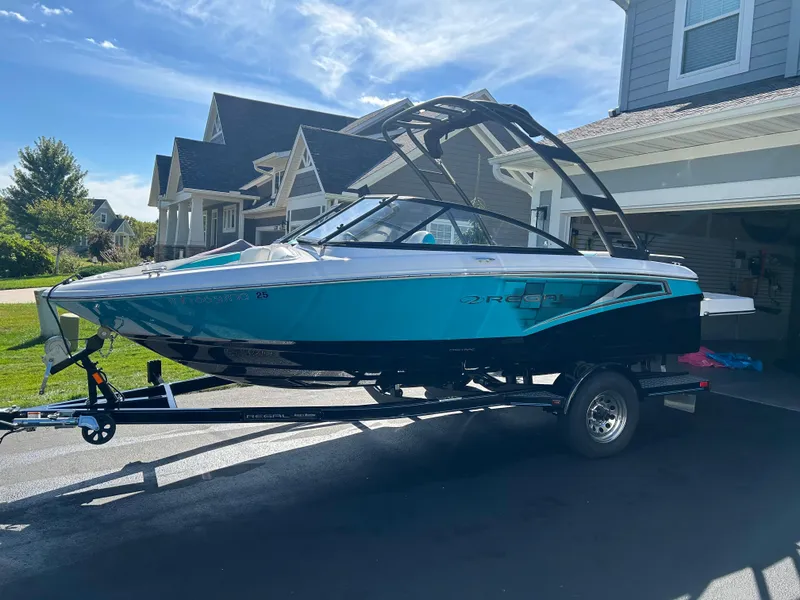 The Image of 2021 Regal 1900 ES Bowrider on trailer, parked in residential driveway. - 0