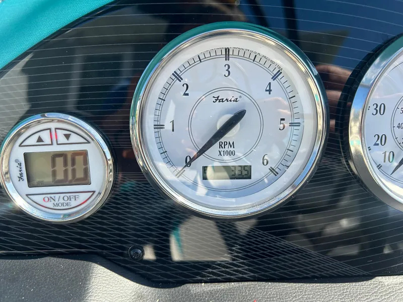 Slide: The Image of Dashboard gauges of 2021 Regal 1900 ES Bowrider boat showing RPM and digital display. - 10