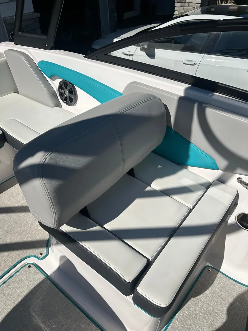 Slide: The Image of 2021 Regal 1900 ES Bowrider interior with gray and teal seating and speaker detail. - 17