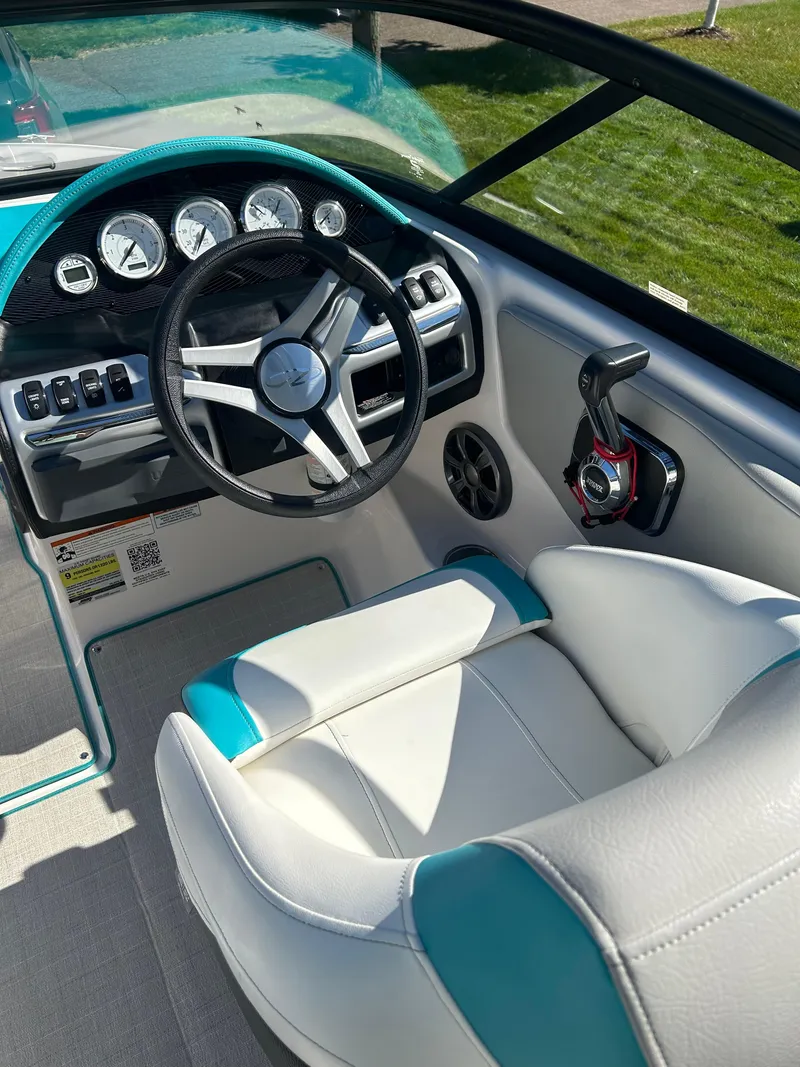 Slide: The Image of Interior of a 2021 Regal 1900 ES Bowrider boat, featuring steering wheel and controls. - 8