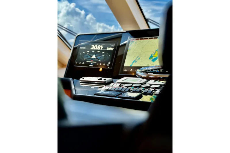Slide: The Image of Control panel of 2008 Hatteras 64 Convertible yacht with navigation screens and instruments. - 16