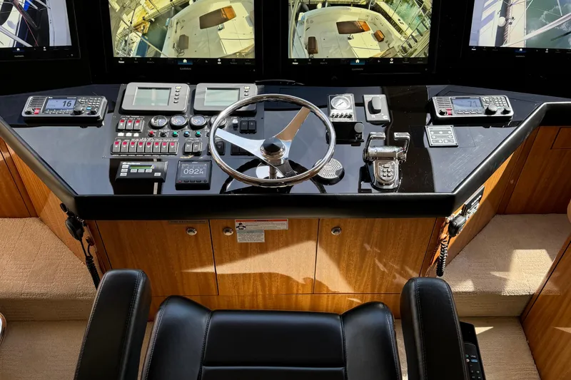 Slide: The Image of Cockpit of 2008 Hatteras 64 Convertible yacht with advanced navigation controls and displays. - 17
