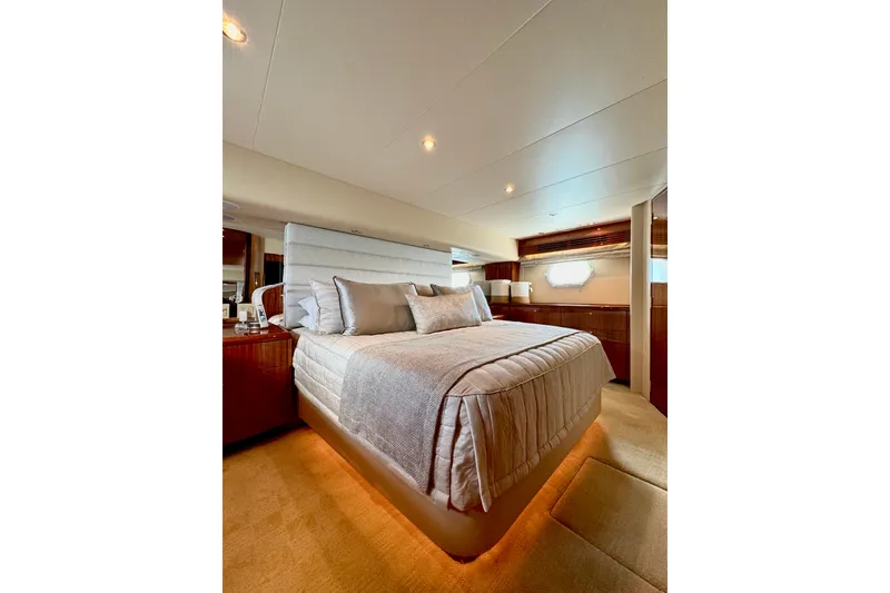 Slide: The Image of Luxurious bedroom interior of 2008 Hatteras 64 Convertible yacht, featuring elegant bedding and ambient lighting. - 19