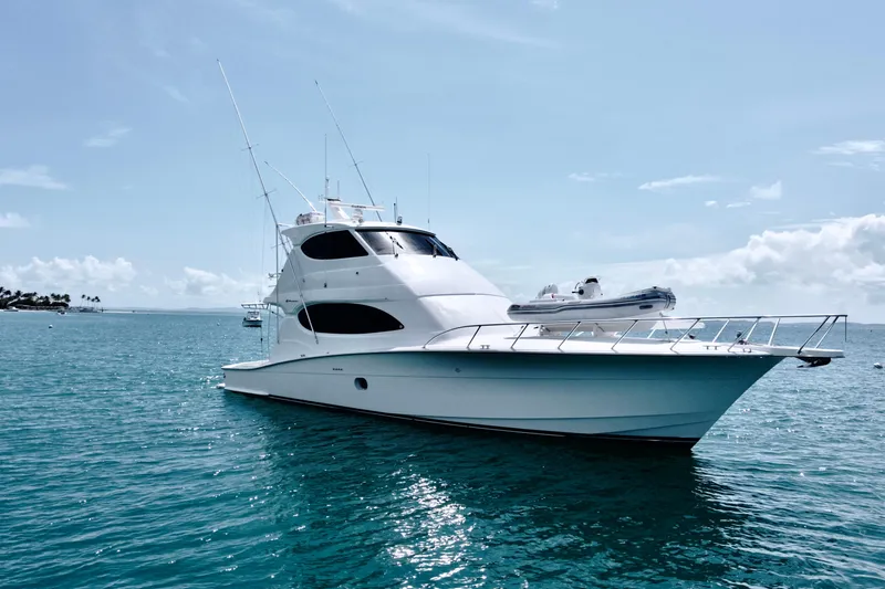 Slide: The Image of 2008 Hatteras 64 Convertible yacht on calm blue ocean waters. - 2