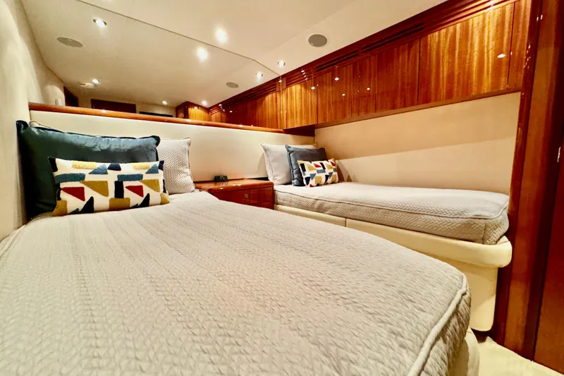 Slide: The Image of Luxurious cabin interior of 2008 Hatteras 64 Convertible yacht with twin beds and elegant wood finish. - 20