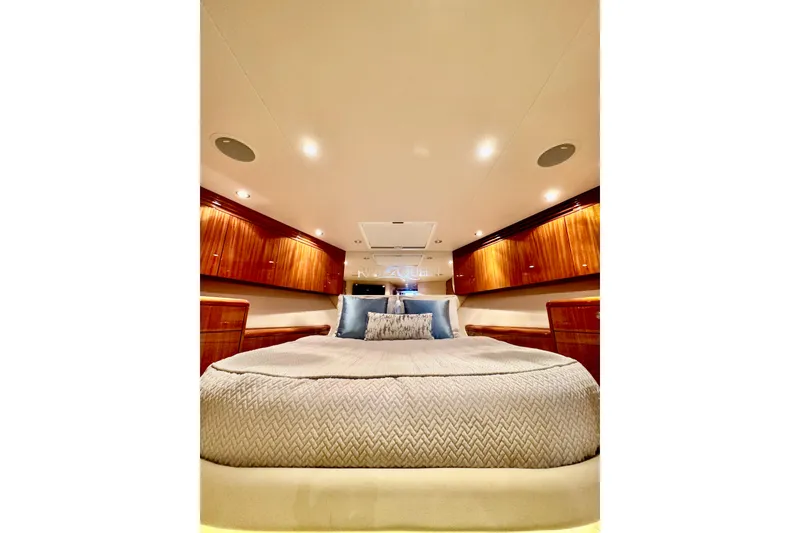 Slide: The Image of Luxurious bedroom interior of 2008 Hatteras 64 Convertible yacht with elegant wood cabinetry. - 21