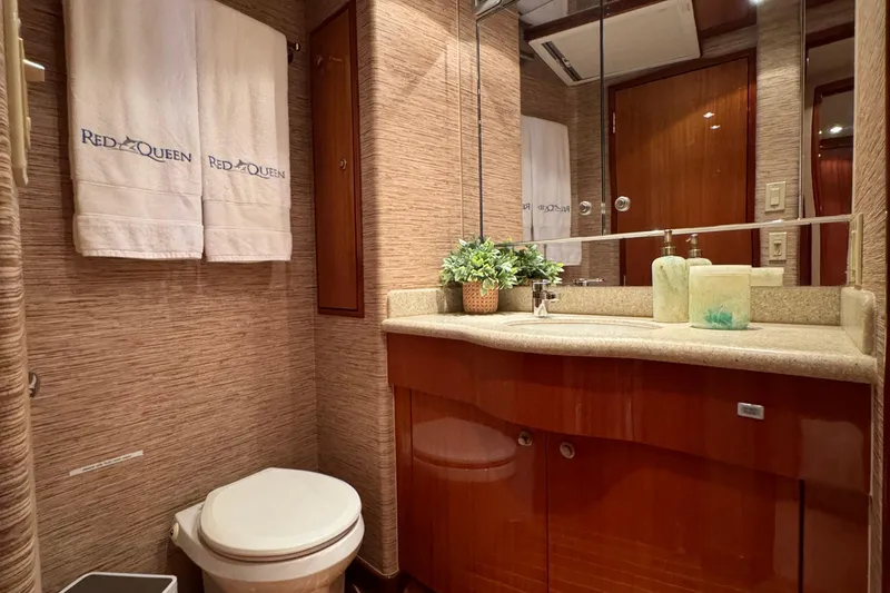 Slide: The Image of Luxurious bathroom in 2008 Hatteras 64 Convertible yacht with elegant wood cabinetry and modern fixtures. - 22