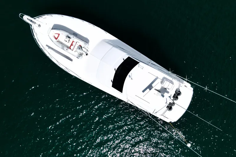 Slide: The Image of Aerial view of 2008 Hatteras 64 Convertible yacht on dark water. - 5