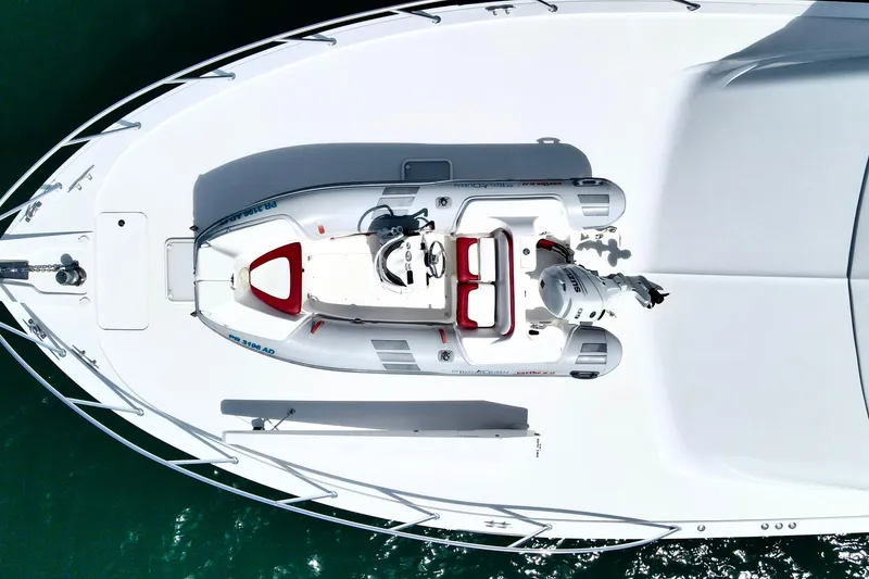Slide: The Image of Aerial view of 2008 Hatteras 64 Convertible yacht with a small boat on deck. - 6