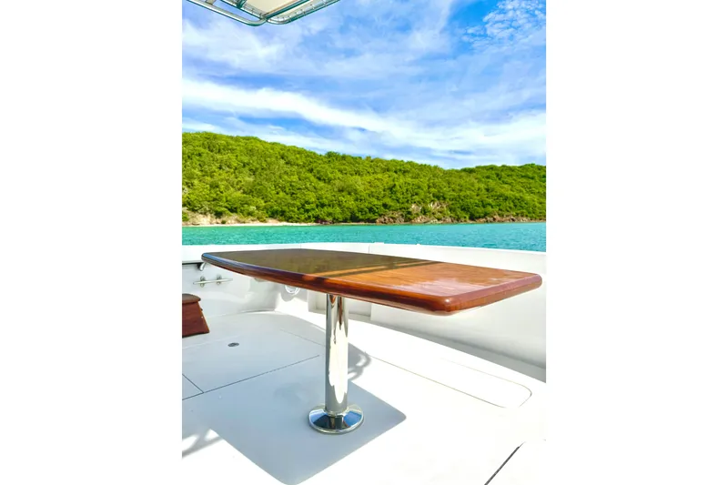 Slide: The Image of Luxury yacht deck with wooden table, Hatteras 64 Convertible, 2008, scenic ocean view. - 8
