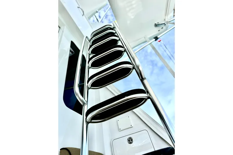 Slide: The Image of Stainless steel ladder on 2008 Hatteras 64 Convertible yacht against blue sky. - 9