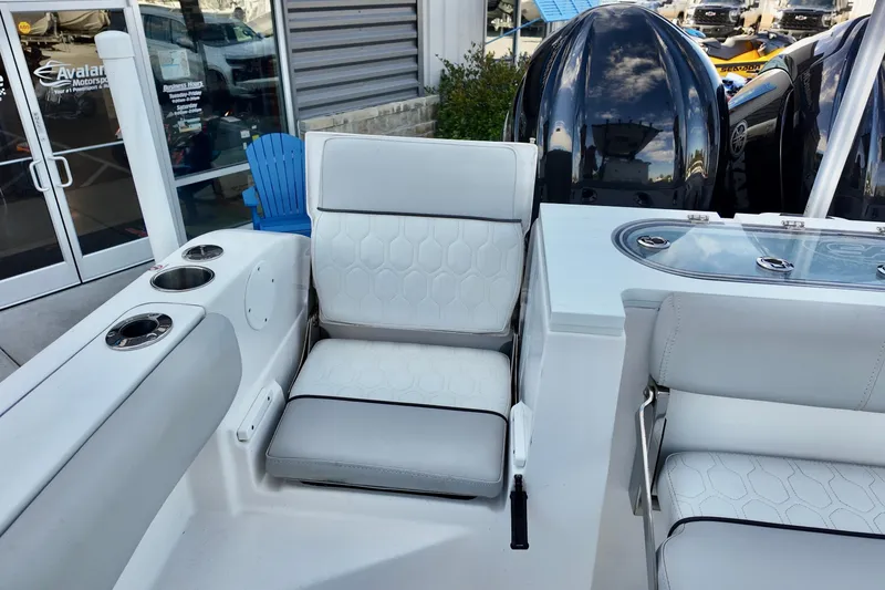 Slide: The Image of 2022 Sea Fox 288 Commander boat interior with white seating and cup holders. - 10