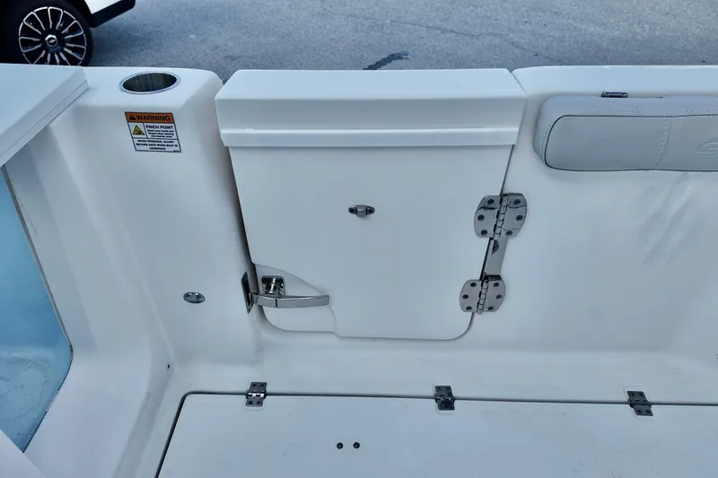 Slide: The Image of 2022 Sea Fox 288 Commander boat interior with storage compartment and safety warning label. - 14