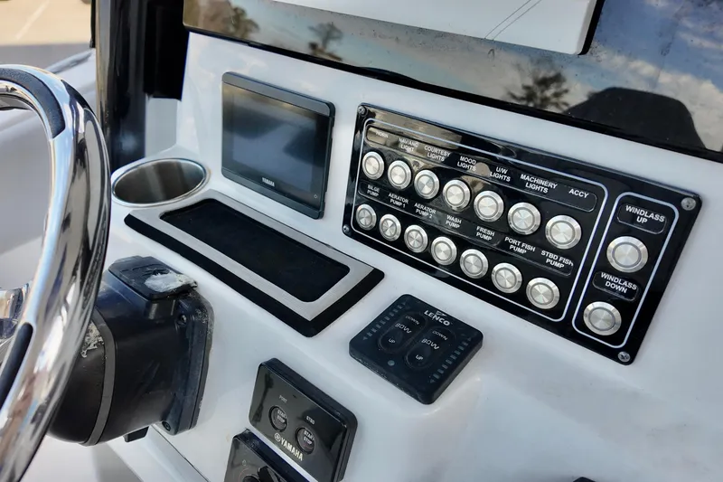 Slide: The Image of Control panel of a 2022 Sea Fox 288 Commander boat with various switches and displays. - 17