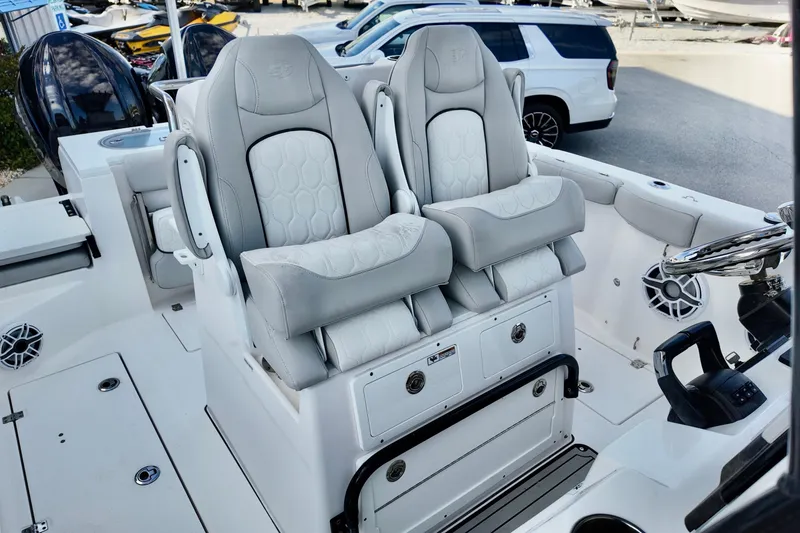 Slide: The Image of 2022 Sea Fox 288 Commander boat interior with dual captain's chairs and steering console. - 21