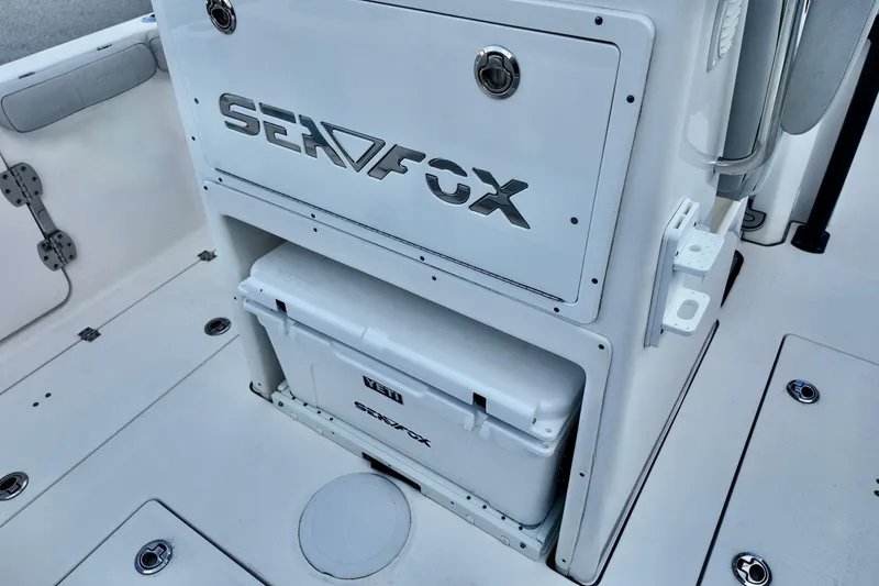 Slide: The Image of 2022 Sea Fox 288 Commander boat interior with storage compartment and cooler. - 22