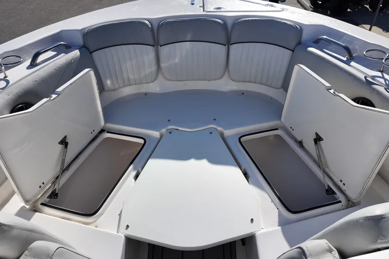 Slide: The Image of 2024 Sea Fox 228 Traveler boat interior with open storage compartments and cushioned seating. - 11
